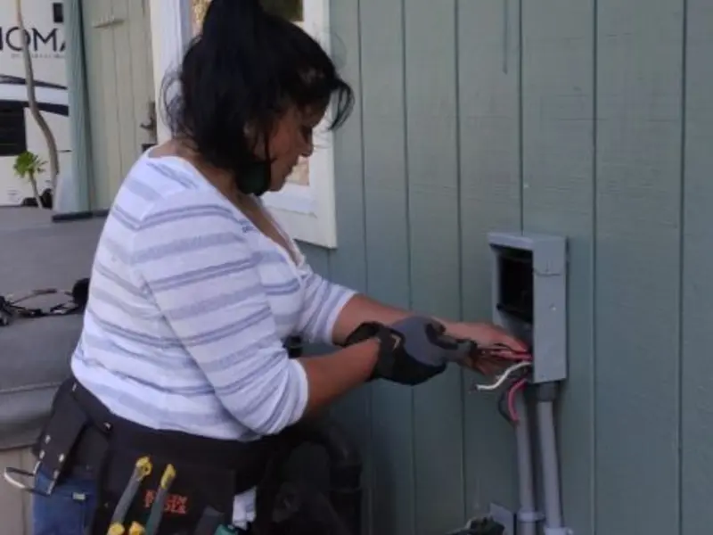 Licensed electrician wiring an exterior subpanel in Ashdown
